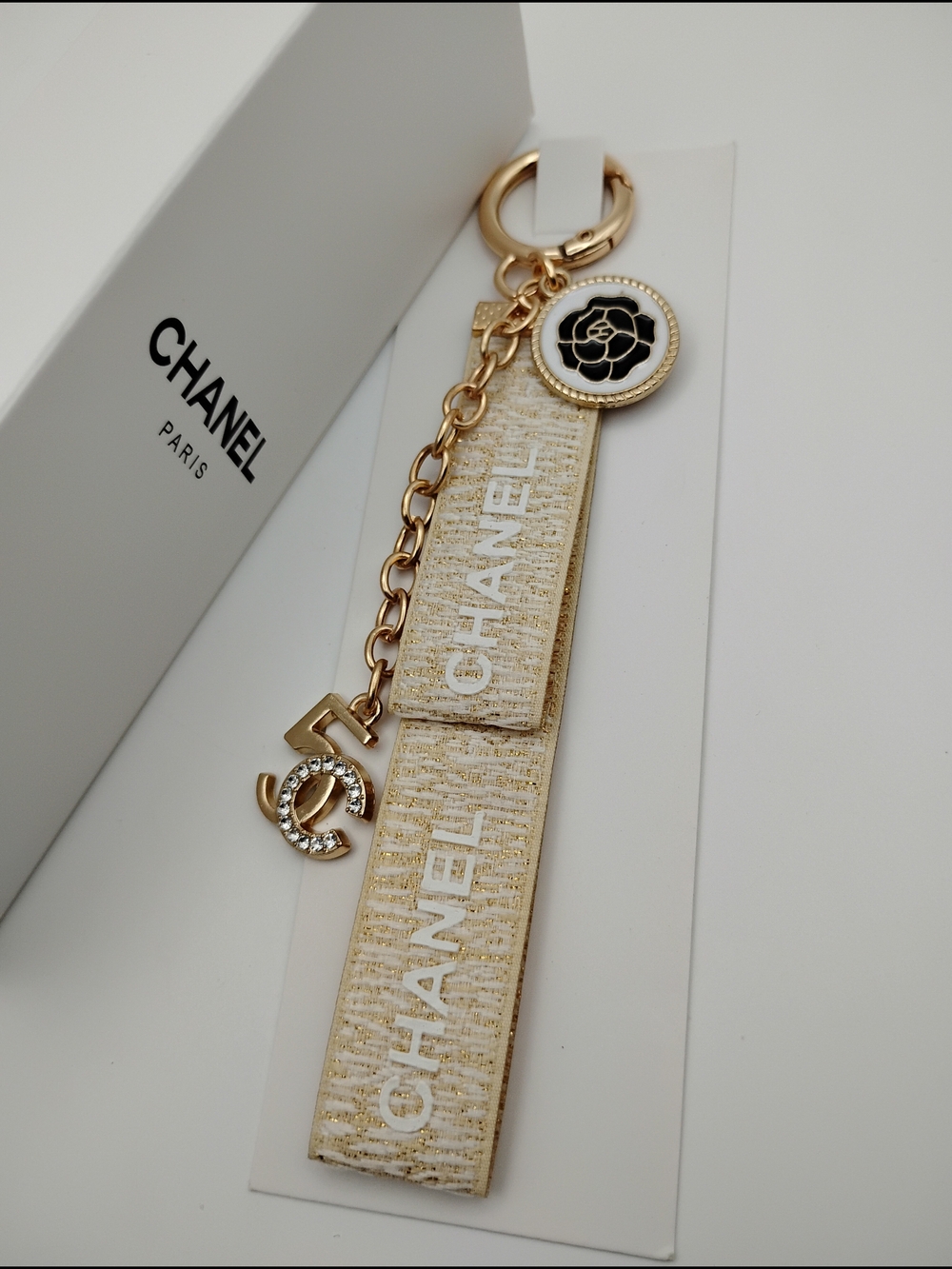 CHANEL Gold and White Logo Tassel Keychain with Camellia Charm